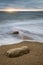 Beautiful vibrant sunset landscape image of Burton Bradstock golden cliffs in Dorest England