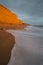 Beautiful vibrant sunset landscape image of Burton Bradstock golden cliffs in Dorest England