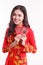 Beautiful Vietnamese woman with red ao dai holding red packet