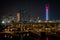 Beautiful view of Abu Dhabi city famous landscape displaying UAE flag, Etihad towers and Marina boats at night