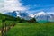 Beautiful view of alpine meadows in the Caucasus mountains. Pastures, meadows on the slopes and snow-capped mountains