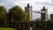 Beautiful view of ancient architecture of fortress and bridge with towers. Action. Tourists walking through old town