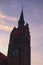 Beautiful view of ancient tower with clock of Evangelical Church of Christ Cz: Evangelicky Kristuv kostel during summer sunset.