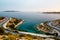 The beautiful view of asphalt serpentine road and sea with islands on the background. Travel in Athens, Greece