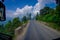 Beautiful view of asphalted road with some motorbikes around in the street, located in Pokhara, Nepal