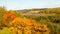 Beautiful view of autumn landscape with yellow trees, hills, lake, meadows and houses, Russia, Pskov, Izborsk