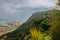 Beautiful view on the Barcelona port. Green hills of the Montjuic mountain. Industrial ships on background. Huge aloe and cactus