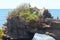 Beautiful view of Batu Bolong Temple by the sea on exotic coral cliffs.