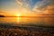 Beautiful view from the beach at the seaside with clouds at suns