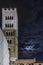 Beautiful view of the bell tower of the Duomo of San Martino with the moon and clouds in the night sky, Lucca, Tuscany, Italy