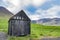 Beautiful view of black faded wooden barn with green grass of sh