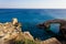 Beautiful view of the blue Mediterranean sea and the rock arch on a Sunny day from Cape Greco in Cyprus. Stone landscape of Ayia
