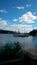 Beautiful view of the boat parking, the river and the magnificent blue sky with white lush clouds