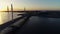 Beautiful view of bridge and city at sunset on summer evening.