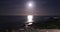 Beautiful view of bright moon above ocean and beach