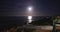 Beautiful view of bright moon above ocean and beach