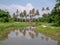 Beautiful view of a cabin surrounded by coconut trees reflecting in the lake at Balik Pulau, Penang