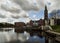 Beautiful view of the canal, bridge, church and houses in the Dutch city of Vlaardingen on a cloudy day