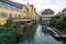 Beautiful View of a canal with a rowboats at historical houses - Small touristic boats at the pier on river Lauch in Petite Venise