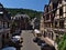 Beautiful view of the center of town Oberwesel with historic buildings, restaurant, parking cars, maypole and waving flags.