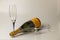 Beautiful view champagne bottle and  two  slim, tall and elegant champagne glasses on background.