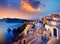 Beautiful view of Churches in Oia village Santorini island in Greece at sunset. Generative AI