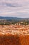 Beautiful view of city skyline, towers, basilicas, red-tiled roofs of houses and mountains, Florence, Italy