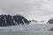 Beautiful view of the clouds over snowy mountains and ice floes in the Arctic