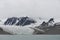 Beautiful view of the clouds over snowy mountains and ice floes in the Arctic