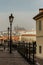 Beautiful view of cobblestone pedestrian street and Prague Castle in morning fog. Tranquil city scene. Walking through