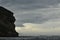 Beautiful view of a colony of puffins flying over the ocean in Iceland on a cloudy day