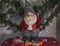 Beautiful view of cute gnome figure on Christmas presents background. Christmas holidays concept.