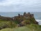 Beautiful view of a Dunluce Castle in Northern Ireland on a cloudy day