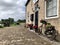 Beautiful view of a dutch barn with an old bicycle decorated with flower baskets