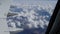 Beautiful view of the earth with clouds from the porthole of the plane during the flight.