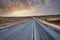 Beautiful view of empty road amidst volcanic landscape against sky during sunset