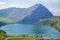 Beautiful view of Enol Lake in Covadonga Lakes, Asturias, Spain. Green grassland with mountains at the background