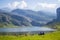 Beautiful view of Ercina Lake in Covadonga Lakes, Asturias, Spain. Green grassland with people relaxing and mountains at the