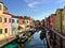 A beautiful view of the famous canals and colourful homes of the island town of Burano, Italy on a beautiful morning.