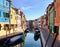 A beautiful view of the famous canals and colourful homes of the island town of Burano, Italy on a beautiful morning.