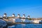 Beautiful view of famous traditional white windmills on hill top, Mykonos, Greece. Whitewashed houses, summer, morning