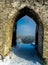 Beautiful view forest through an archway of the ruins of the old castle