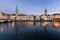 Beautiful view of Fraumunster Church and old town zurich by limmat river before sunrise