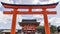 Beautiful view of the Fushimi Inari Shrine in Kyoto, Japan, framed in a red door