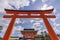 Beautiful view of the Fushimi Inari Shrine in Kyoto, Japan, framed in a red door