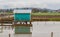 Beautiful view of the green boathouse on the water with reflection.