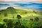 Beautiful view of green fields and meadows at sunset in Tuscany