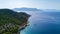 Beautiful view of green peninsula with yachts and boats near it in Greece