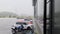 Beautiful view of heavy rain falling on private cars parked near industrial building