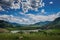 Beautiful view from hill to the confluence of two rivers under a blue sky with clouds in the Altai mountains. Amazing landscape of